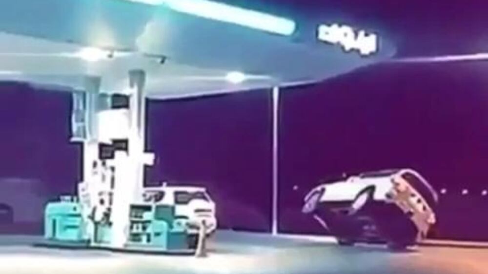 20151221 - driver doing wheelies at a gas station -bv