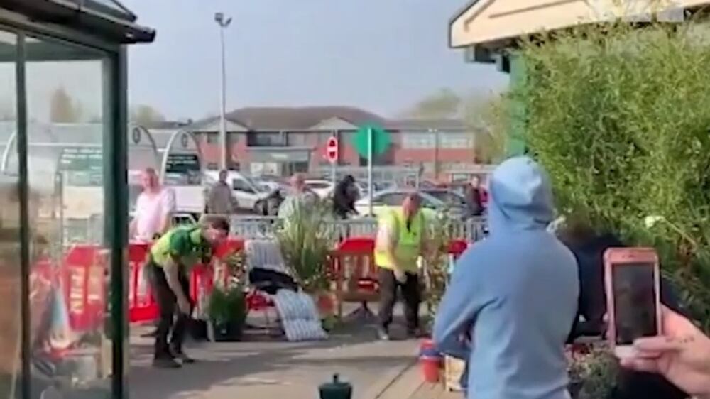 UK supermarket workers dance for queuing shoppers