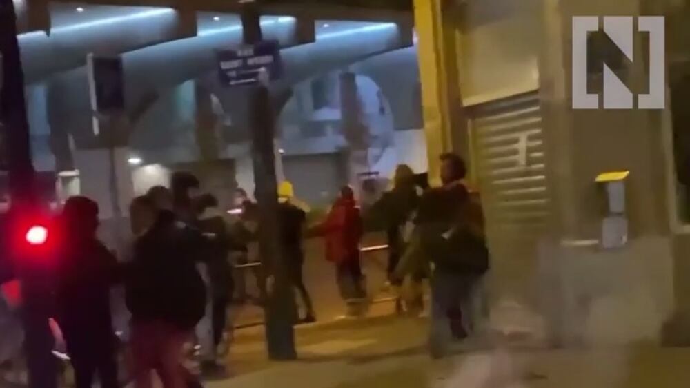 Police use tear gas as they dismantle a new migrant camp in the centre of Paris