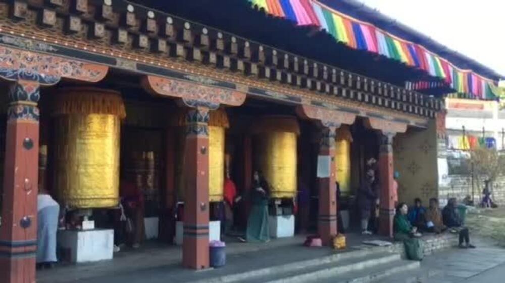 Families turn prayer wheels at the National Memorial Chorten in Thimphu, Bhutan