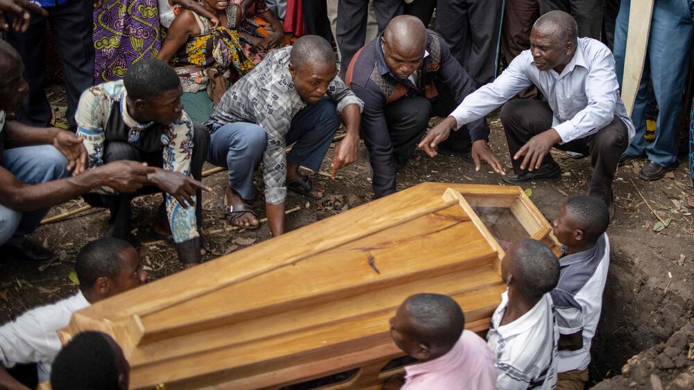 Families bury loved ones after militants kill 37 in Uganda