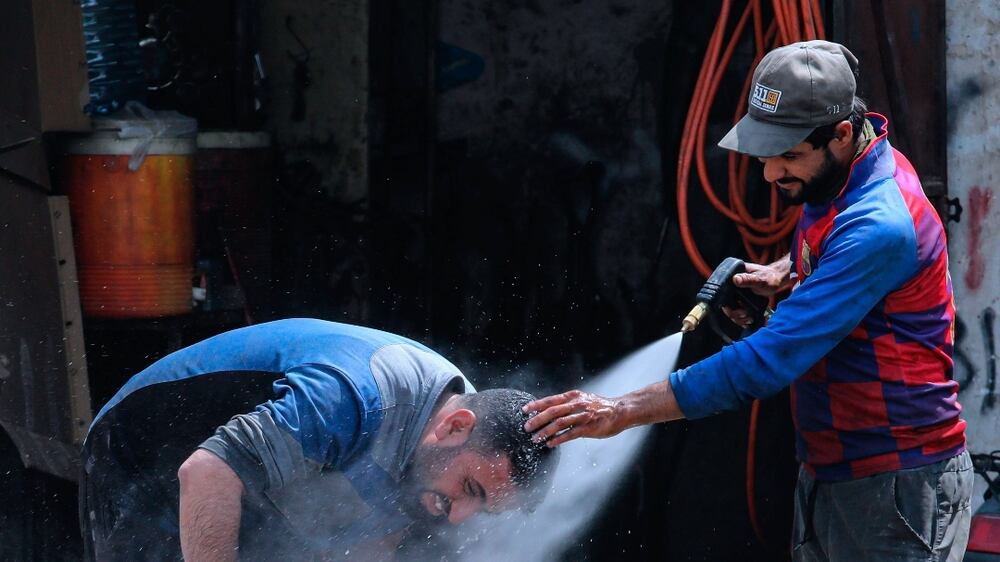 A man cools off from the summer heat as the temperature reached 123. 8 F (51 C) in Basra, Iraq on Thursday, July 1, 2021.  Iraq's government declared Thursday an official holiday in Baghdad due to a scorching heatwave.  v (AP Photo / Nabil al-Jurani)