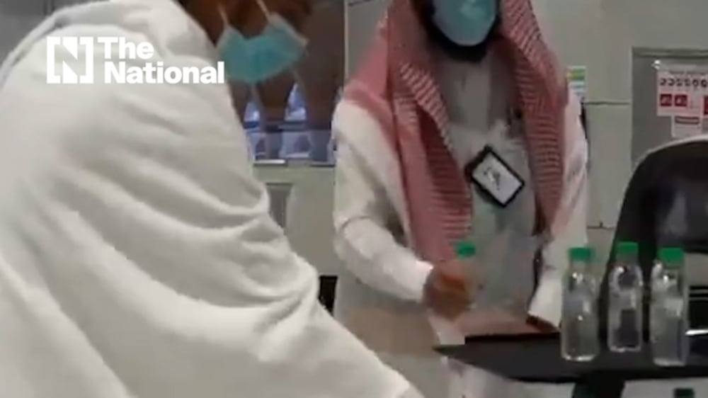 Robots serve Zamzam water bottles at the Grand Mosque in Makkah