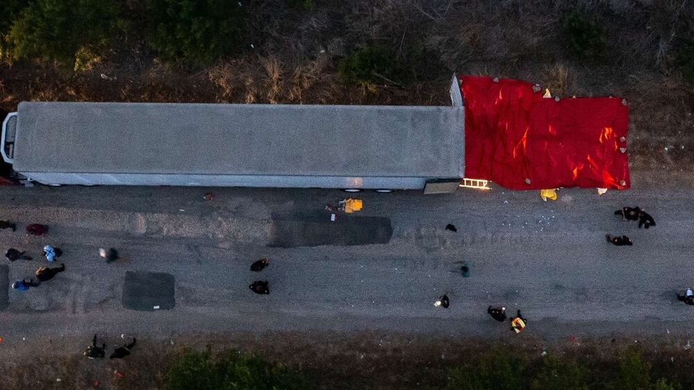SAN ANTONIO, TX - JUNE 27: In this aerial view, members of law enforcement investigate a tractor trailer on June 27, 2022 in San Antonio, Texas.  According to reports, at least 46 people, who are believed migrant workers from Mexico, were found dead in an abandoned tractor trailer.  Over a dozen victims were found alive, suffering from heat stroke and taken to local hospitals.    Jordan Vonderhaar / Getty Images / AFP
