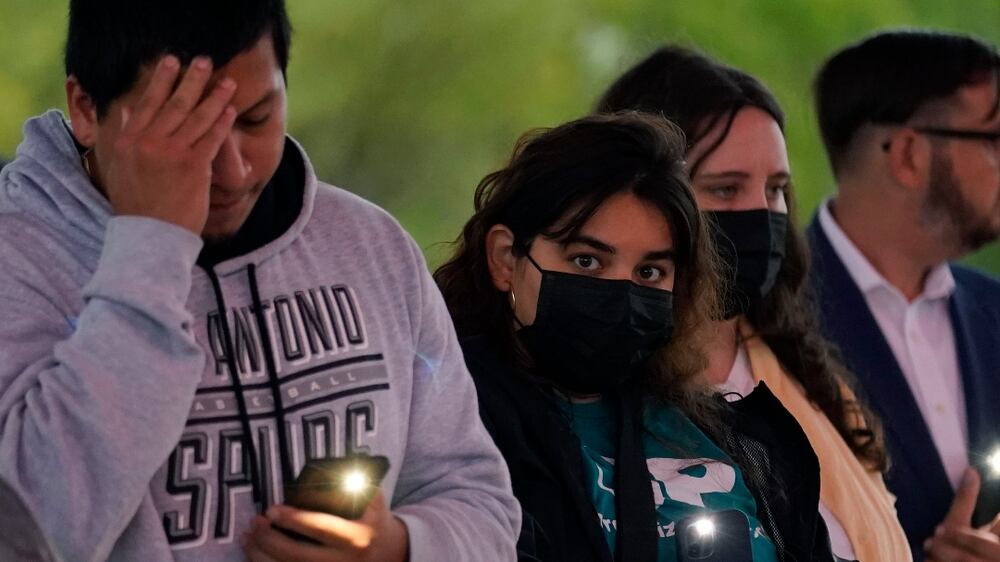 Members of the community take part in a vigil for the dozens of people have been found dead Monday in a semitrailer containing suspected migrants, Tuesday, June 28, 2022, in San Antonio.  (AP Photo / Eric Gay)