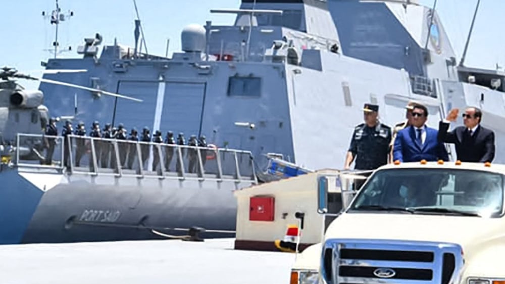 A handout picture released by the Egyptian Presidency on July 3, 2021 shows Egyptian President Abdel Fattah al-Sisi (C), accompanied by Abu Dhabi Crown Prince and Deputy Supreme Commander of the United Arab Emirates Armed Forces Sheikh Mohammed bin Zayed Al-Nahyan (C-R), riding in a vehicle next to a warship during the inauguration of the new "July 3" naval base in Gargoub, about 80 kilometres west of Egypt's northwestern Mediterranean coastal city of Masra Matruh.  (Photo by -  /  EGYPTIAN PRESIDENCY  /  AFP)  /  === RESTRICTED TO EDITORIAL USE - MANDATORY CREDIT "AFP PHOTO  /  HO  /  EGYPTIAN PRESIDENCY' - NO MARKETING NO ADVERTISING CAMPAIGNS - DISTRIBUTED AS A SERVICE TO CLIENTS ==