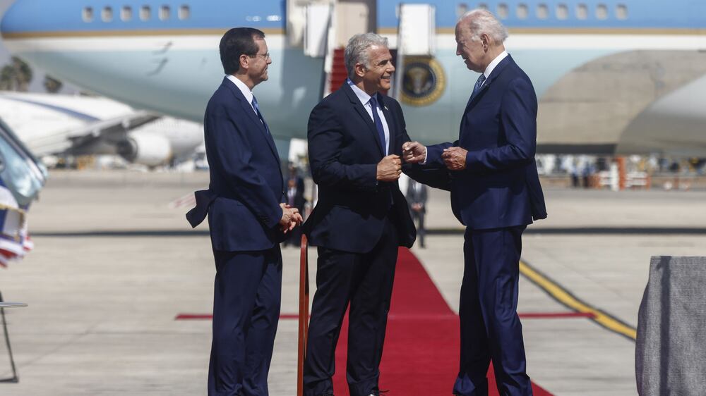 Isaac Herzog, Israel's president, left, Yair Lapid, Israel's prime minister, center, and US President Joe Biden, during an arrival ceremony at Ben Gurion International Airport in Tel Aviv, Israel, on Wednesday, July 13, 2022.  President Biden will seek to salvage relations with Saudi Arabia during a Mideast trip that risks political embarrassment unless near-record US gasoline prices swiftly come back to Earth. Photographer: Kobi Wolf / Bloomberg
