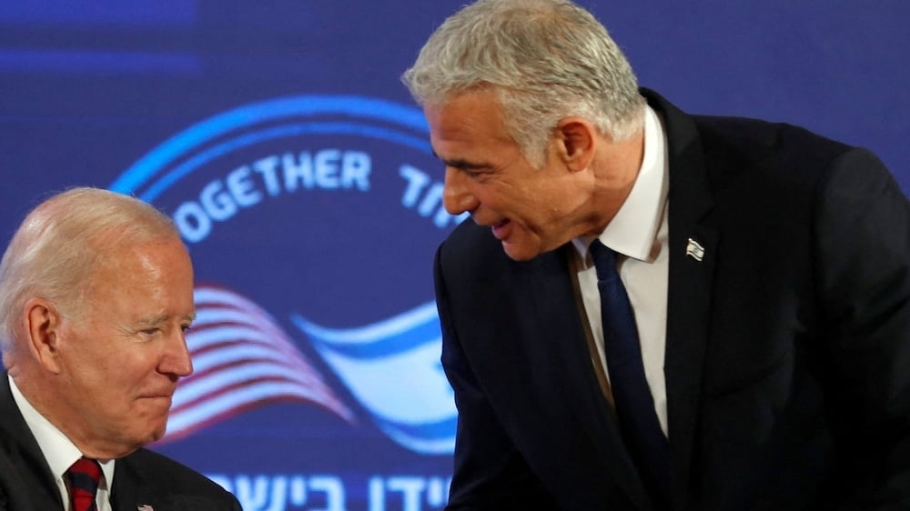 U. S.  President Joe Biden and Israeli Prime Minister Yair Lapid shake hands as they sign a security pledge at Waldorf Astoria Hotel in Jerusalem, Israel July 14, 2022.   Atef Safadi / Pool via REUTERS