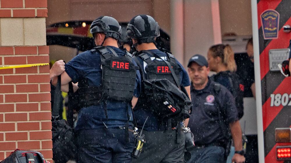 Law enforcement wait outside after a deadly shooting Sunday, July 17, 2022, at the Greenwood Park Mall, in Greenwood, Ind.  (Kelly Wilkinson / The Indianapolis Star via AP)