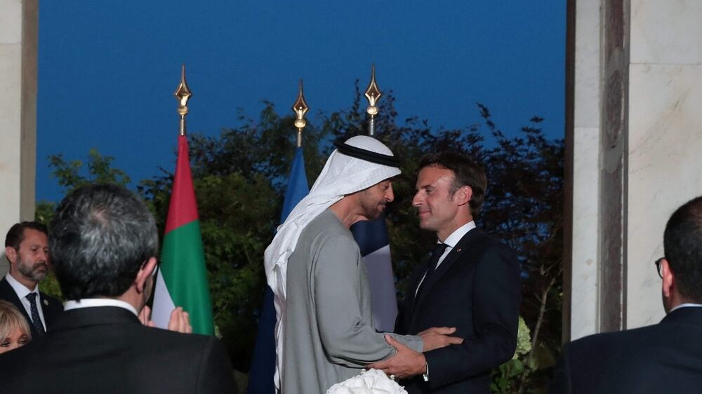 French President Emmanuel Macron (C-R) and United Arab Emirates’ President Sheikh Mohammed Bin Zayed take part in a state dinner at the Grand Trianon estate near the Palace of Versailles, south west of Paris, on July 18, 2022.  (Photo by Christophe PETIT TESSON  /  POOL  /  AFP)