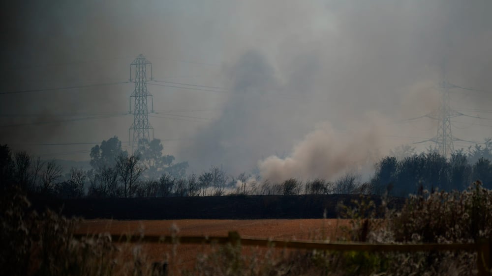 A blaze is in the village of Wennington, east London, Tuesday, July 19, 2022.  The typically temperate nation of England is the latest to be walloped by unusually hot, dry weather that has triggered wildfires from Portugal to the Balkans and led to hundreds of heat-related deaths.  (Yui Mok / PA via AP)