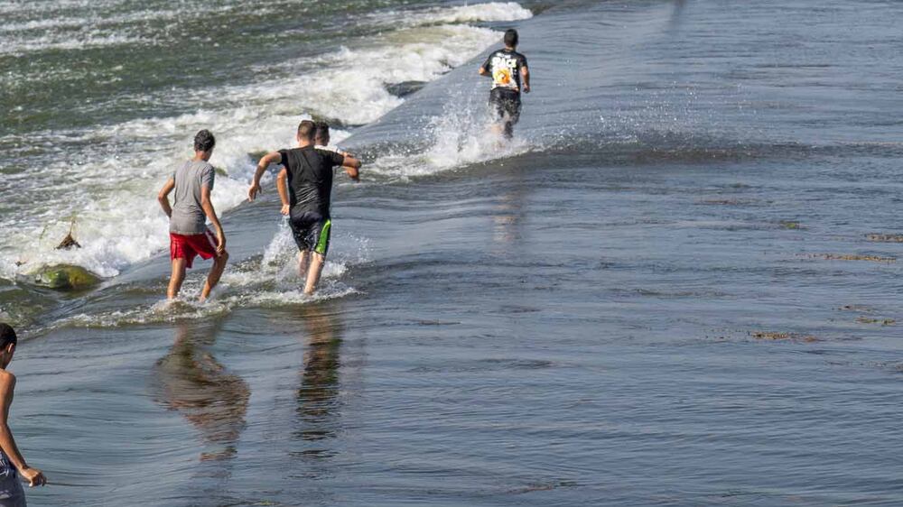 Boys swim in the Nile to beat heatwave in Cairo