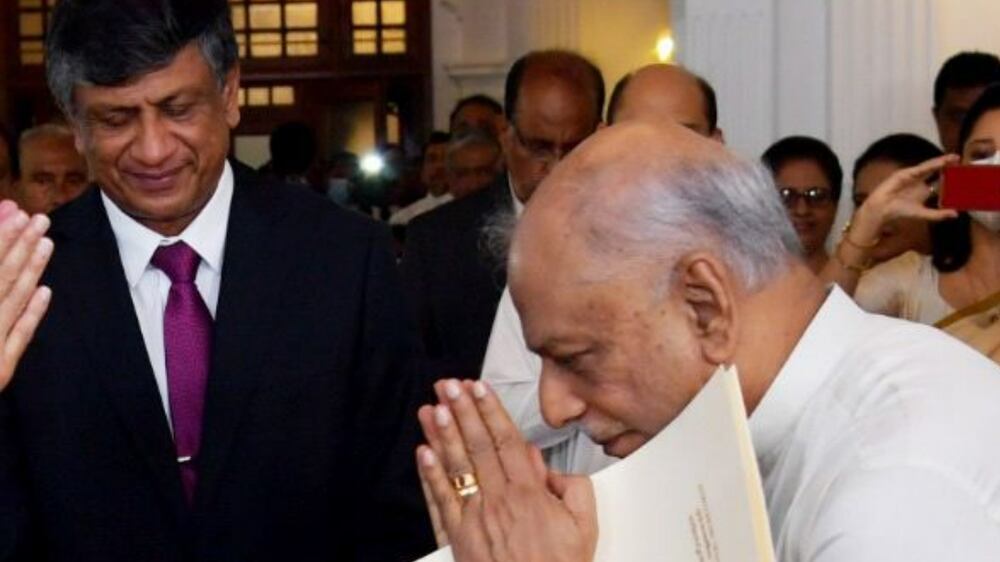 A handout photo made available by the Sri Lankan president's media division shows Dinesh Gunawardena (R) being sworn in as the new Prime Minister of Sri Lanka in front of President Ranil Wickremesinghe (L) in Colombo, Sri Lanka, 22 July 2022.  Former Leader of the House in the Parliament and former Foreign Minister Dinesh Gunawardena was appointed as the new Prime Minister of Sri Lanka after the Sri Lankan parliament elect Ranil Wickremesinghe as the new President of Sri Lanka on 20 July, after accepting the resignation of President Gotabaya Rajapaksa who fled to Singapore through the Maldives following months of anti-government protests fueled by the ongoing economic crisis.   EPA / Sri Lankan President Media Division HANDOUT  HANDOUT EDITORIAL USE ONLY / NO SALES