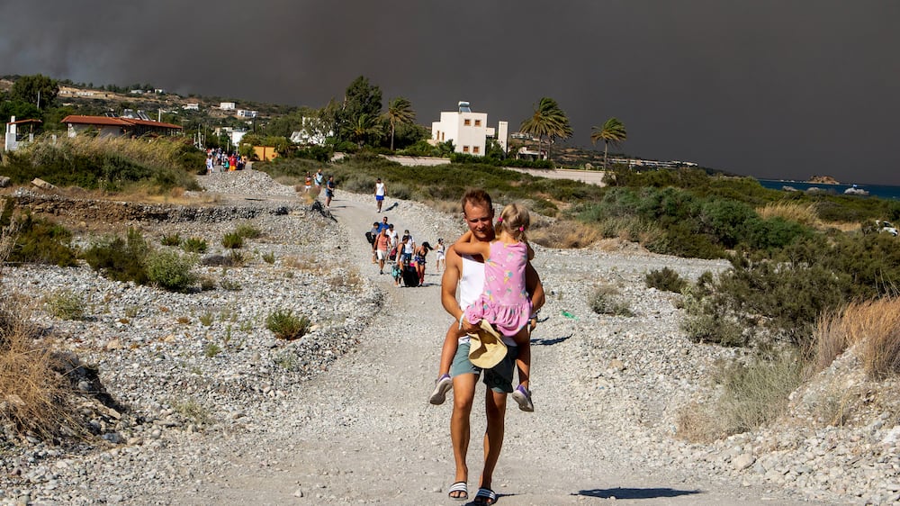 Thousands of tourists and locals flee as wildfires rage on Greek island of Rhodes