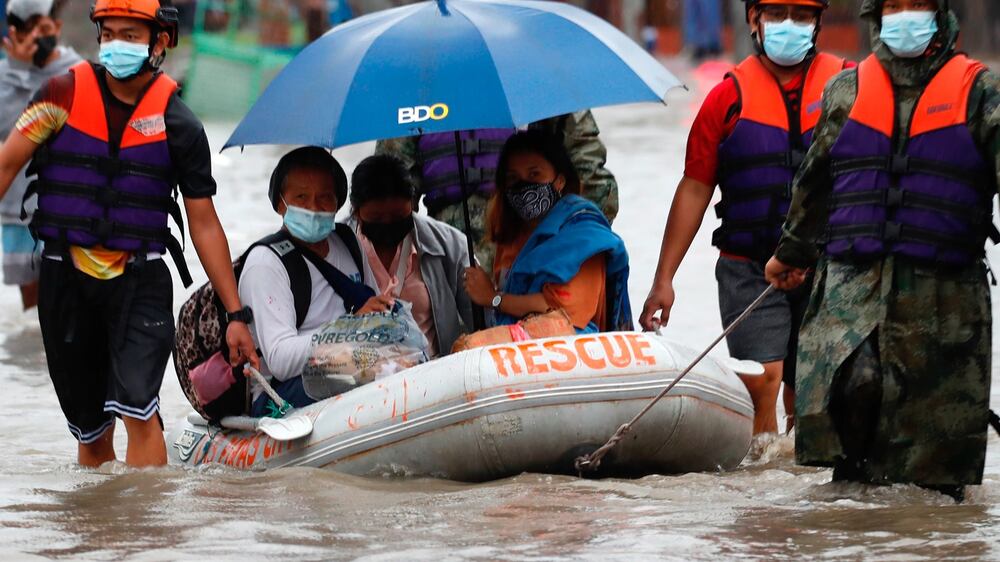 Thousands evacuated as monsoon rains and tropical storm cause flooding in Manila