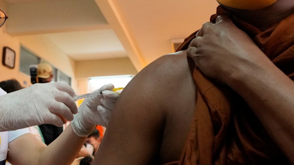 A health worker administers a dose of the AstraZeneca COVID-19 vaccine to a Buddhist monk at Wat Srisudaram in Bangkok, Thailand, Friday, July 30, 2021.  (AP Photo / Sakchai Lalit)