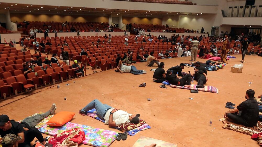 Iraqi protesters rest inside the Parliament building in Baghdad, Iraq, Sunday, July 31, 2022. (AP Photo / Anmar Khalil)