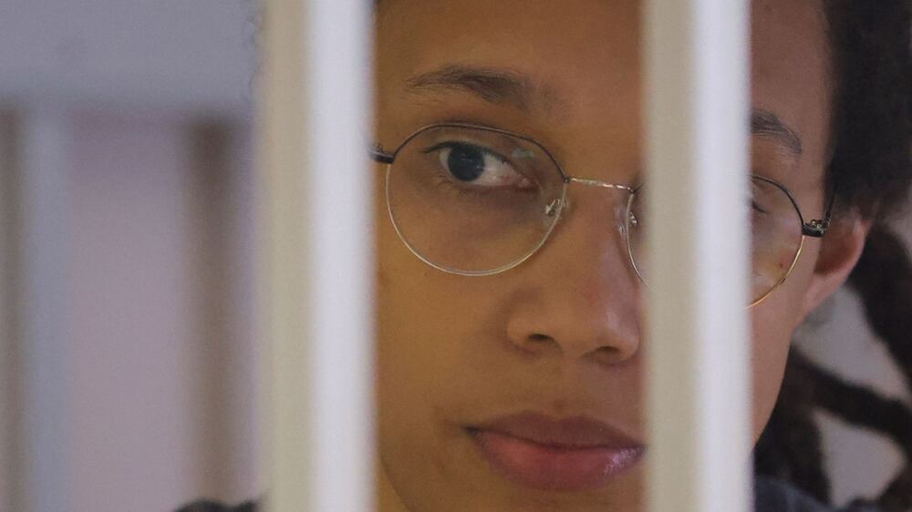 US' Women's National Basketball Association (NBA) basketball player Brittney Griner, who was detained at Moscow's Sheremetyevo airport and later charged with illegal possession of cannabis, waits for the verdict inside a defendants' cage before a court hearing in Khimki outside Moscow, on August 4, 2022.  - A Russian court found Griner guilty of smuggling and storing narcotics after prosecutors requested a sentence of nine and a half years in jail for the athlete.  (Photo by EVGENIA NOVOZHENINA  /  POOL  /  AFP)