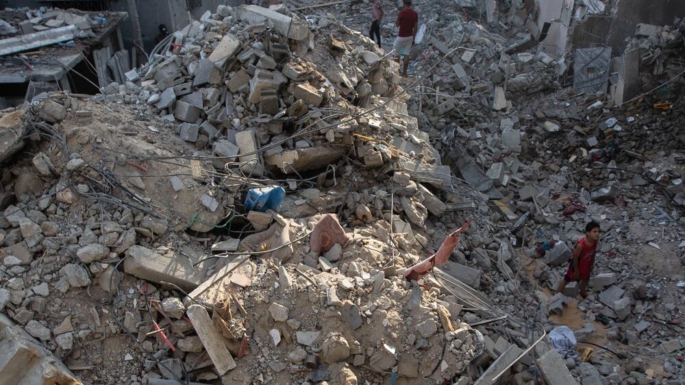 Palestinians search through the rubble of a building in which Khaled Mansour, a top Islamic Jihad militant was killed following an Israeli airstrike in Rafah, southern Gaza strip, Sunday, Aug.  7, 2022.  An Israeli airstrike killed a senior commander in the Palestinian militant group Islamic Jihad, authorities said Sunday, its second leader to be slain amid an escalating cross-border conflict.  (AP Photo / Yousef Masoud)