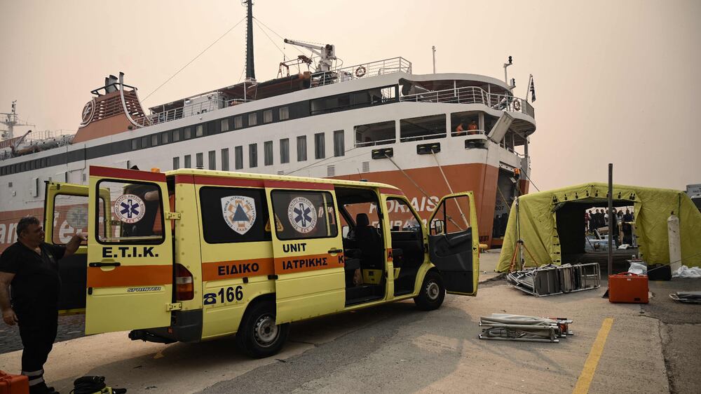 Greek medics rush to evacuate patients on to ferry as wildfire rages near hospital