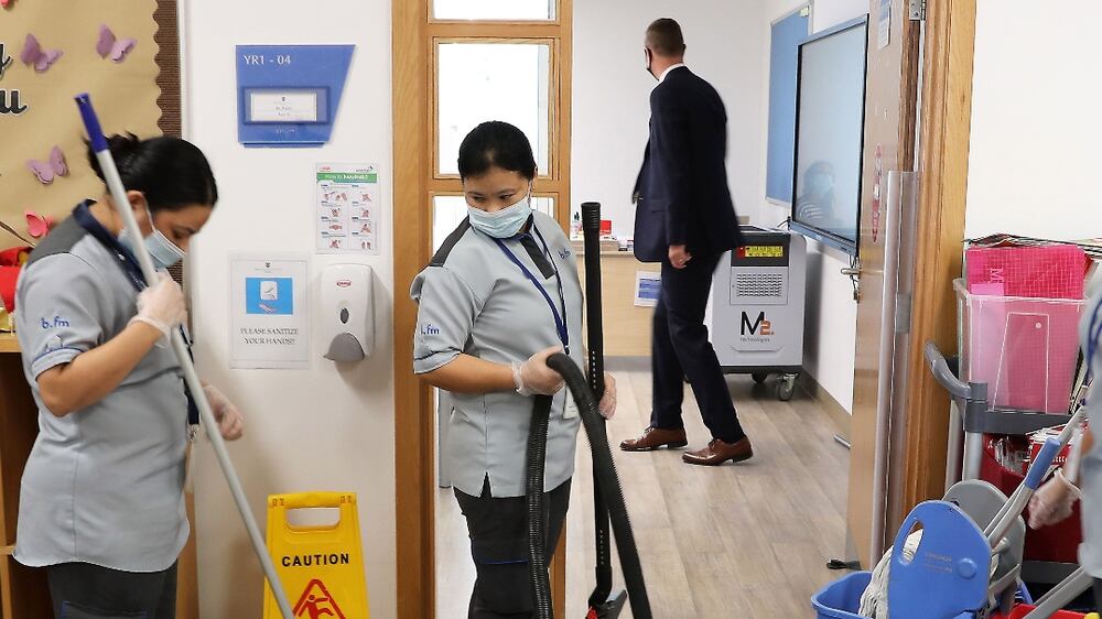 Staff cleaning the doors, classrooms, corridors at the Brighton College Dubai in Al Barsha South in Dubai on 24 August,2021. Deep cleaning and sanitization is going on at the school ahead of students returning back to the campus on 29 August. Pawan Singh/The National. Story by Anam