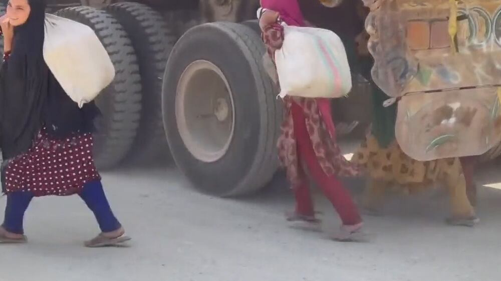 Afghan children hide under trucks to sell handmade goods