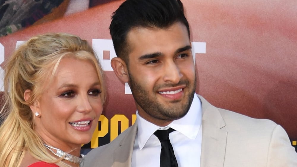 (FILES) In this file photo taken on July 22, 2019 US singer Britney Spears (L) and boyfriend Sam Asghari arrive for the premiere of Sony Pictures' "Once Upon a Time. . .  in Hollywood" at the TCL Chinese Theatre in Hollywood, California.  - op princess Britney Spears on September 12, 2021 announced her engagement to her boyfriend Sam Asghari via social media.  (Photo by VALERIE MACON  /  AFP)