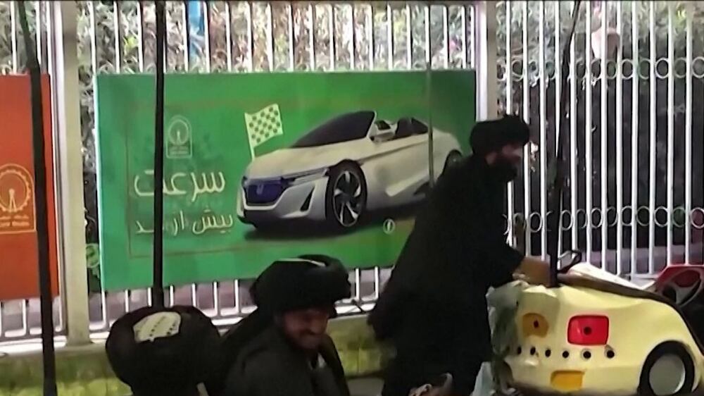 Taliban ride bumper cars at Kabul amusement park