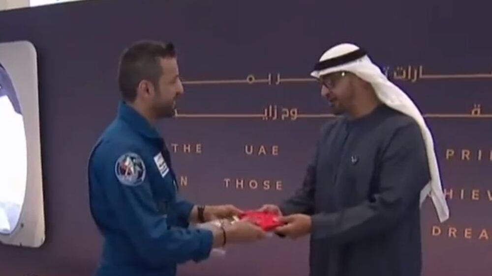 Astronaut Sultan Al Neyadi hands UAE flag to President Sheikh Mohamed