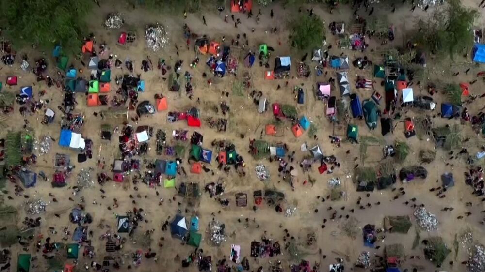 Drone footage shows over 10,000 people camped under Texas bridge