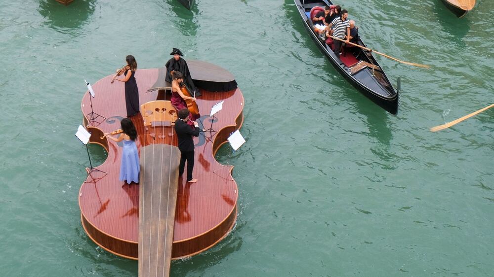 Watch a string quartet perform on a giant floating violin in Venice