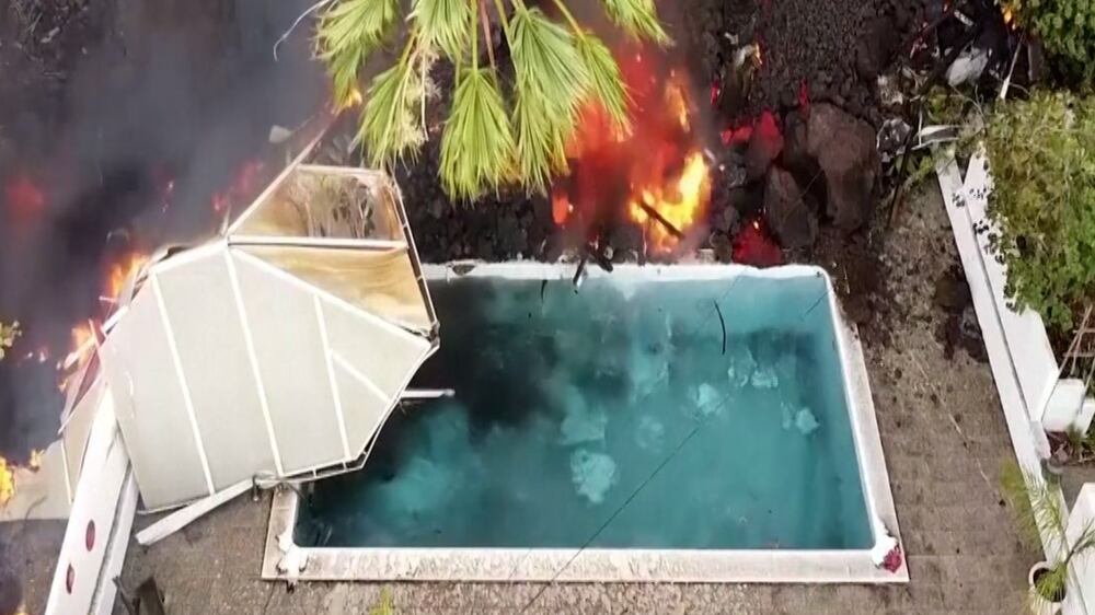 Watch the moment lava from La Palma volcano in Spain falls into a pool