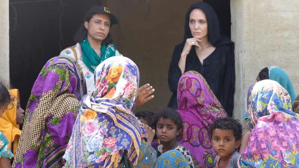 A handout photo made available by the International Rescue Committee (IRC) shows US actor and activist Angelina Jolie (C-R) talking with women affected by floods in Dadu, Sindh province, Pakistan, 20 September 2022 (issued 21 September 2022).  Jolie arrived in Pakistan on 20 September, on a trip intended to draw international attention to the country's unfolding humanitarian crisis in the wake of unprecedented rains and floods.  According to the country's National Disaster Management Authority, a total 1,559 people, including 551 children, have died and more than 33 million people have been displaced since the monsoon season started in mid-June.   EPA / SAIMA JAVED / IRC HANDOUT  HANDOUT EDITORIAL USE ONLY / NO SALES