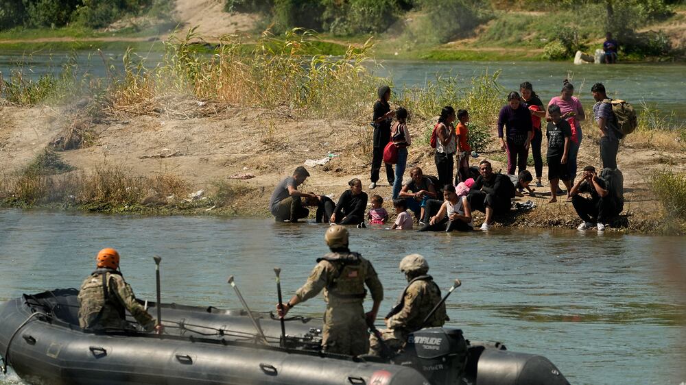 Desperate asylum seekers cross river between US and Mexico amid migrant surge