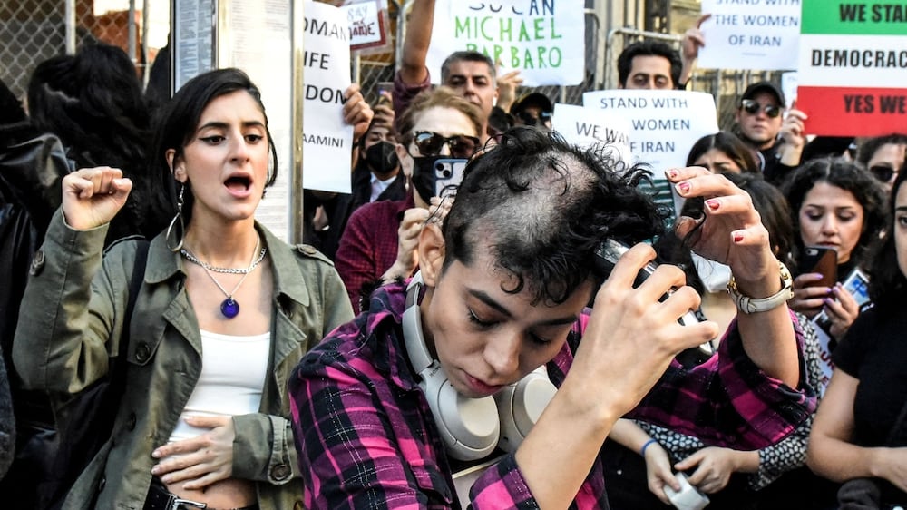 Protesters shave their heads outside New York Times building