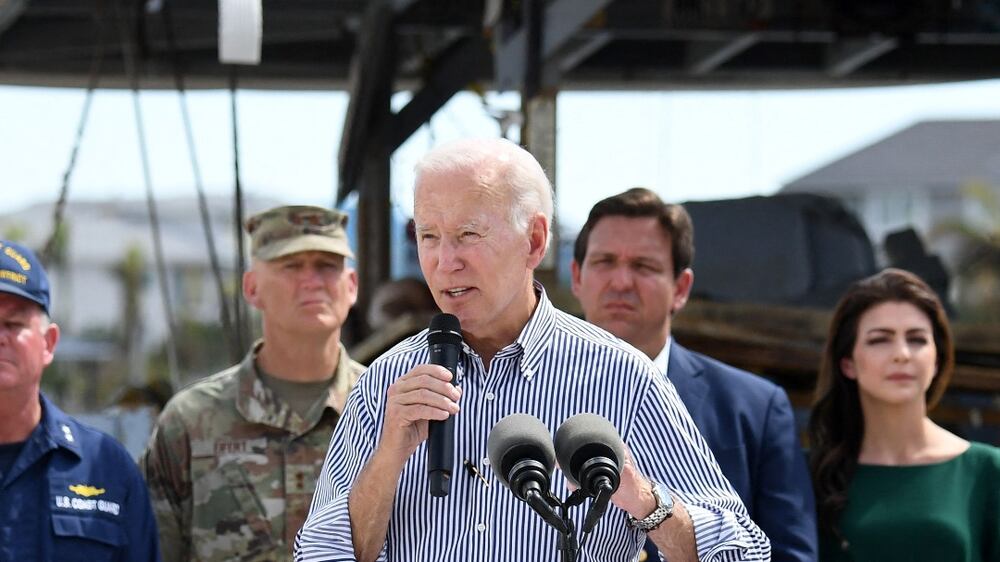 US President Joe Biden speaks in a neighborhood impacted by Hurricane Ian at Fisherman’s Pass in Fort Myers, Florida, on October 5, 2022.  (Photo by OLIVIER DOULIERY  /  AFP)