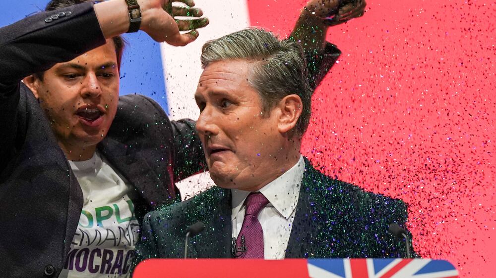 Labour's Keir Starmer covered in glitter by protester during conference speech