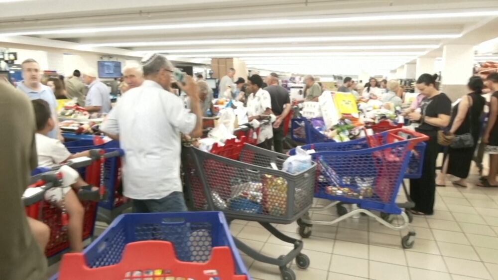 Israelis form long queues in supermarkets and Gaza under 'complete siege'
