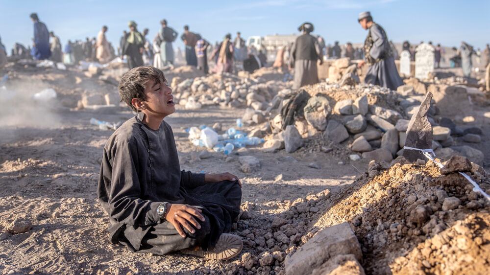 Afghans mourn family members killed in earthquake as mass funeral held