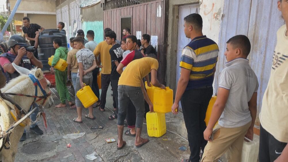 Palestinians wait in long queues for water and food in Gaza