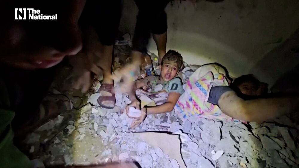 Palestinian children are rescued from the rubble after Israeli airstrike