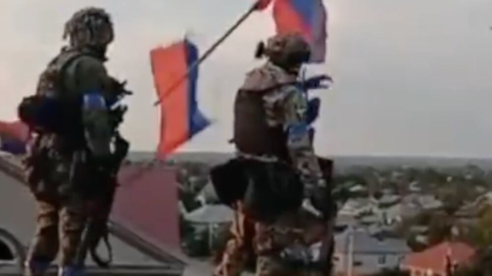 Military footage shows Ukraine soldiers dismantling Russian flags in a liberated area