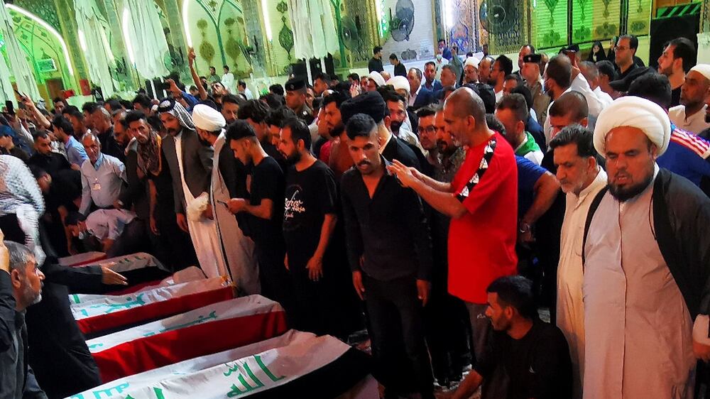 Mourners attend the funeral of those killed in ISIS attack in Iraq