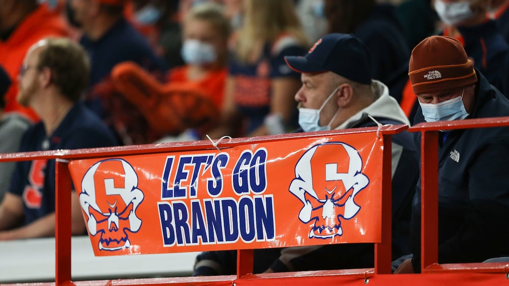 A sign reading "Let's go Brandon" is displayed on the railing in the first half of an NCAA college football game between Boston College and Syracuse in Syracuse, N. Y. , Saturday, Oct.  30, 2021.  Critics of President Joe Biden have come up with the cryptic new phrase to insult the Democratic president.  (AP Photo / Joshua Bessex)