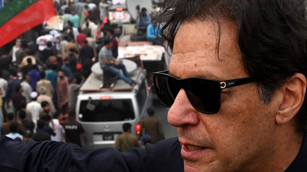 In this photograph taken on November 1, 2022, Pakistan's former prime minister Imran Khan speaks while taking part in an anti-government march in Gujranwala.  - Khan was shot in the foot at a political rally on November 3, 2022 but he is in a stable condition, an aide said.  (Photo by Arif ALI  /  AFP)