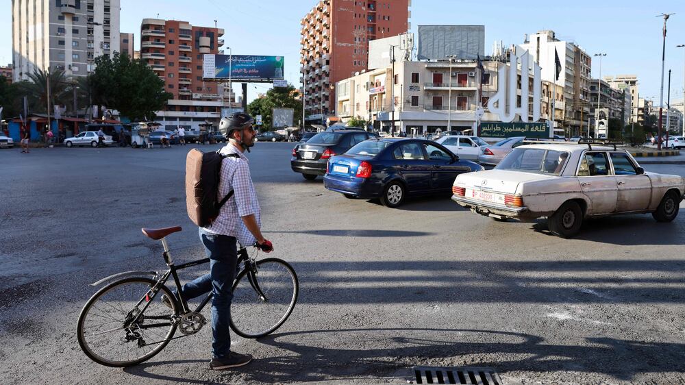 Lebanese Natheer Halawani rides a bicyle in the city of Tripoli north of Beirut on October 6, 2021.  - By challenging Lebanon's national passion for automobile ownership, and driving growing numbers towards greener or more collective transport, the economic crisis is succeeding where everything else failed.  (Photo by Joseph EID  /  AFP)