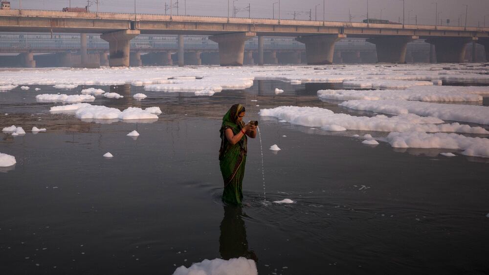 Hindus bathe in India's sacred Yamuna river, despite toxic foam