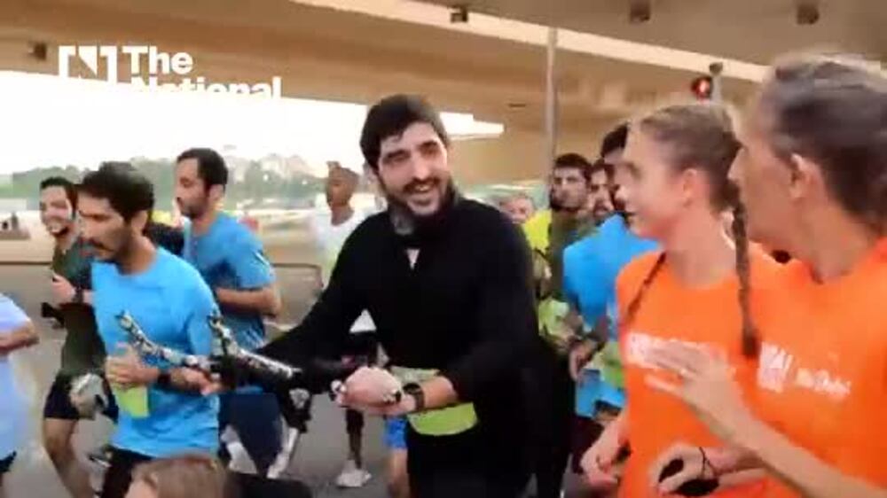 Sheikh Hamdan helps push a young Dubai Run participant
