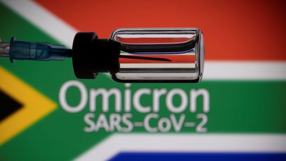 A vial and a syringe are seen in front of a displayed South Africa flag and words "Omicron SARS-CoV-2" in this illustration taken, November 27, 2021. REUTERS/Dado Ruvic/Illustration