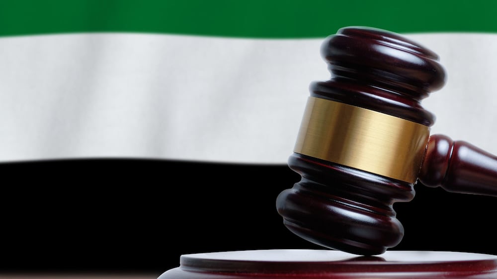 2C9B1G0 Justice and court concept in United Arab Emirates. Judge hammer on a UAE flag background.